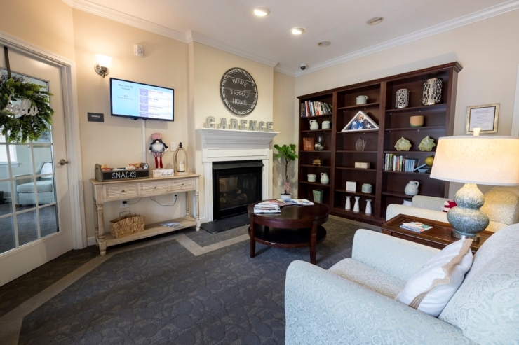 A welcoming lounge featuring comfortable seating, a warm fireplace, and a vibrant community atmosphere.