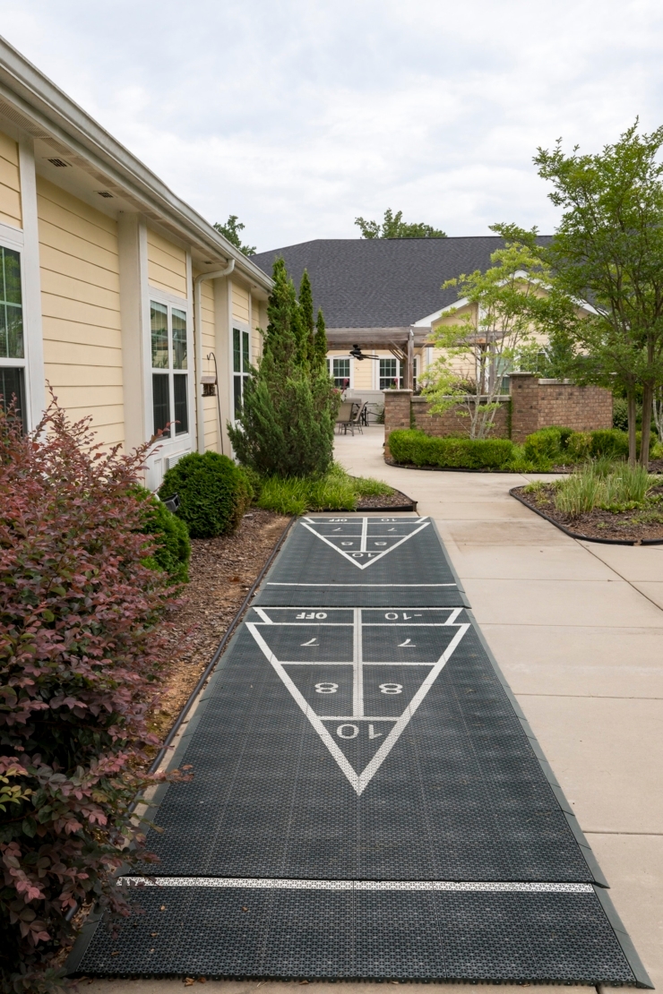 A welcoming pathway leads through lush greenery, inviting residents to enjoy leisure and community.