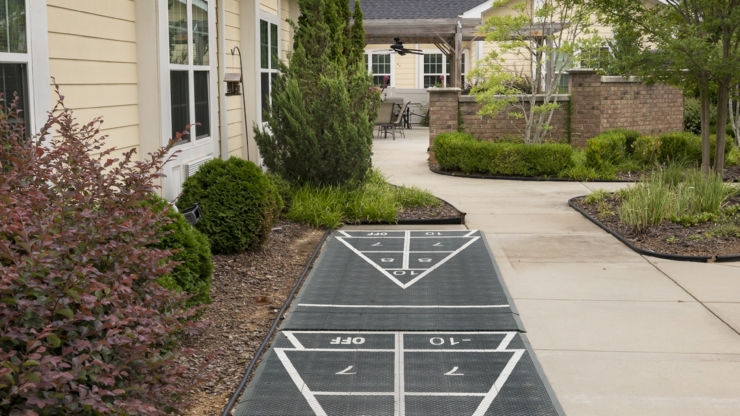 A welcoming pathway leads through lush greenery, inviting residents to enjoy leisure and community.