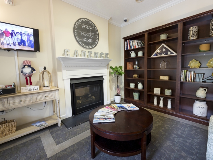 A cozy common area features a warm fireplace, inviting décor, and a friendly atmosphere for residents.