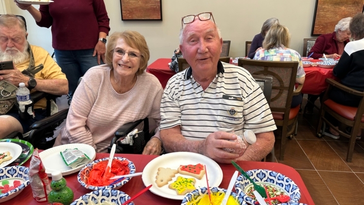 Residents enjoy a lively gathering, sharing smiles and colorful treats in a warm, inviting atmosphere.