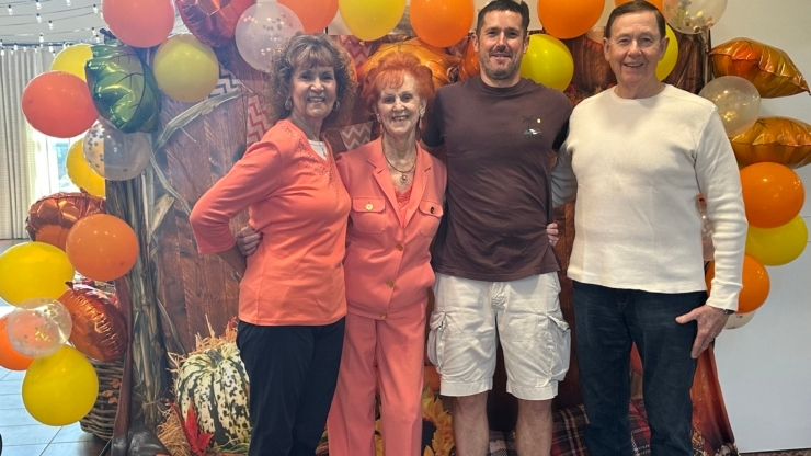 A vibrant gathering of smiling residents and family, celebrating together in a festive atmosphere.