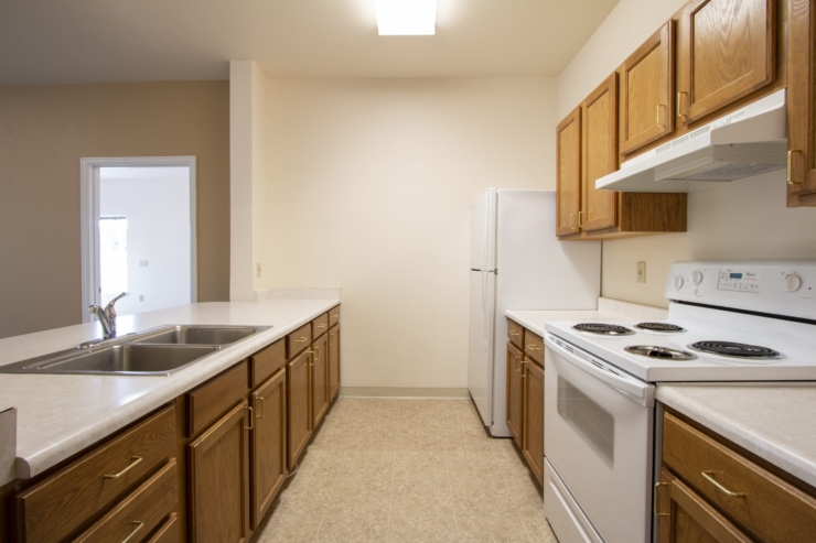 A bright, inviting kitchen with warm wood cabinetry, perfect for gathering and creating meals together.