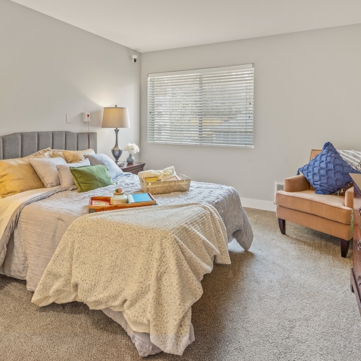 A warm, inviting bedroom filled with natural light, perfect for relaxation and community connection.