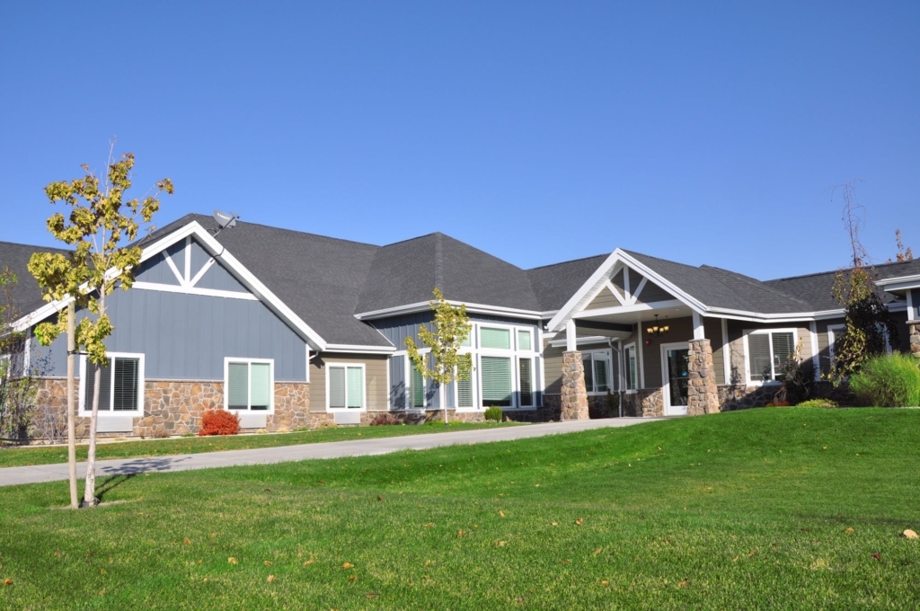 A warm, inviting community space surrounded by lush greenery and bright blue skies.