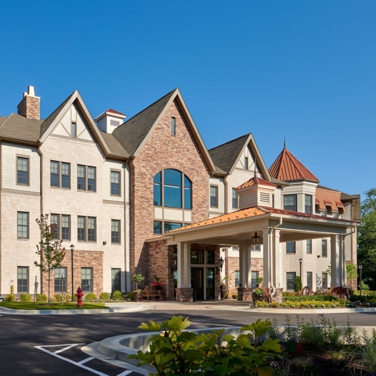 A charming retirement community features elegant architecture, vibrant gardens, and inviting outdoor spaces.