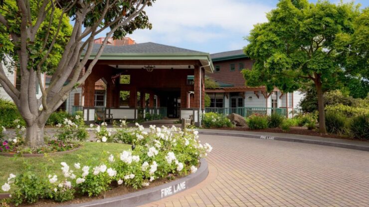 A welcoming entrance surrounded by vibrant flowers and greenery, inviting a sense of community and comfort.