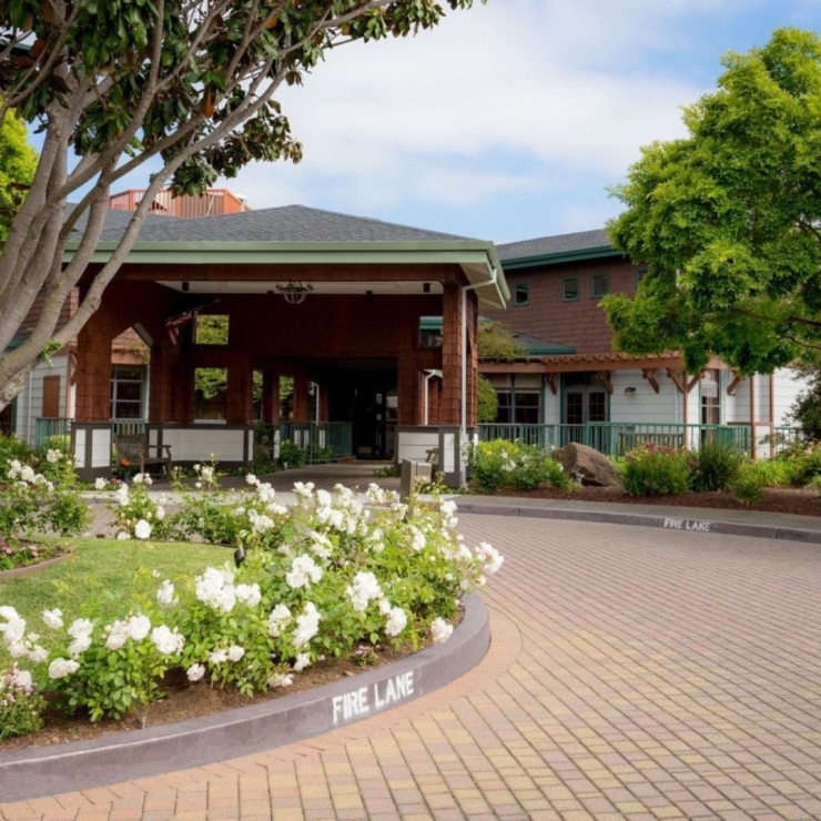 A welcoming entrance surrounded by vibrant flowers and greenery, inviting a sense of community and comfort.