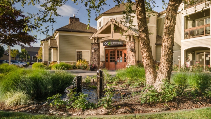 Welcoming entrance surrounded by lush greenery, fostering a warm community atmosphere for all.