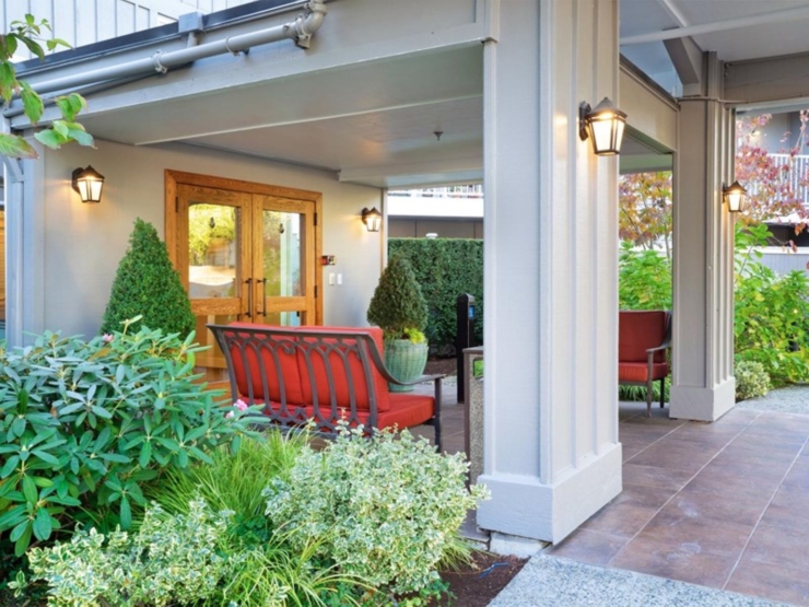 Welcoming entrance with cozy seating and vibrant greenery, fostering a sense of community and comfort.