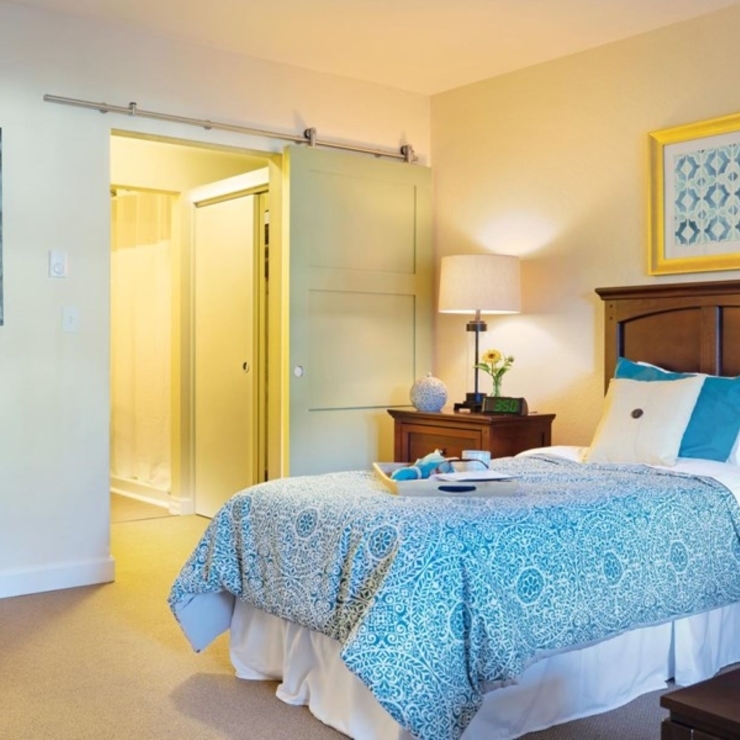 A bright, inviting bedroom showcases comfort with elegant decor, fostering a warm community atmosphere.