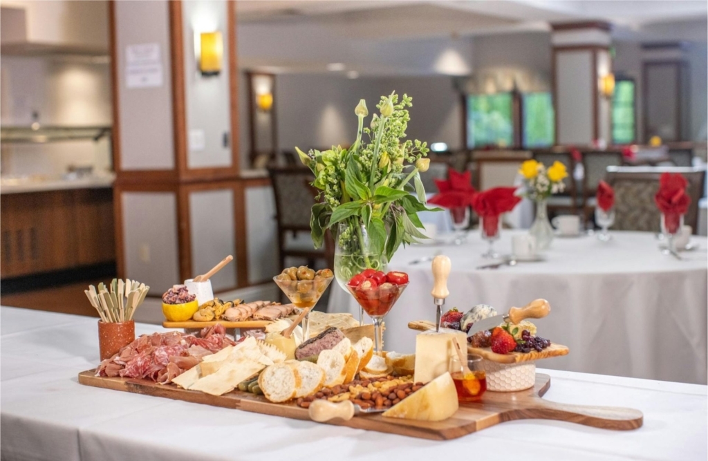 A beautifully arranged charcuterie spread invites warmth and community in a cozy dining area.