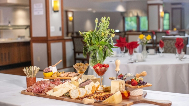 A beautifully arranged charcuterie spread invites warmth and community in a cozy dining area.