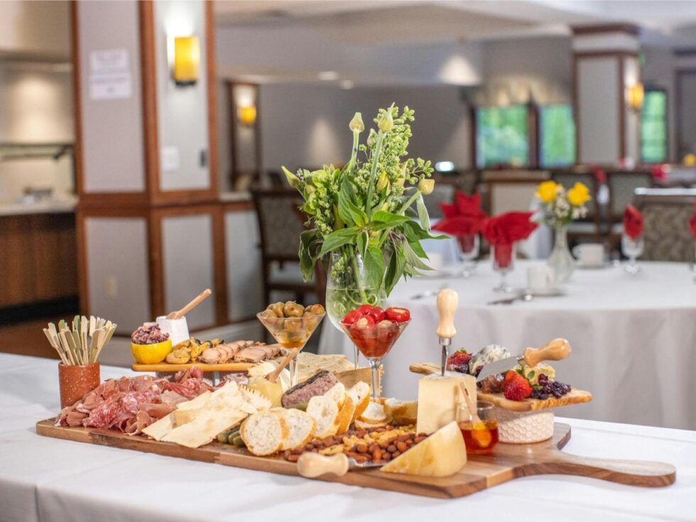 A beautifully arranged charcuterie spread invites warmth and community in a cozy dining area.