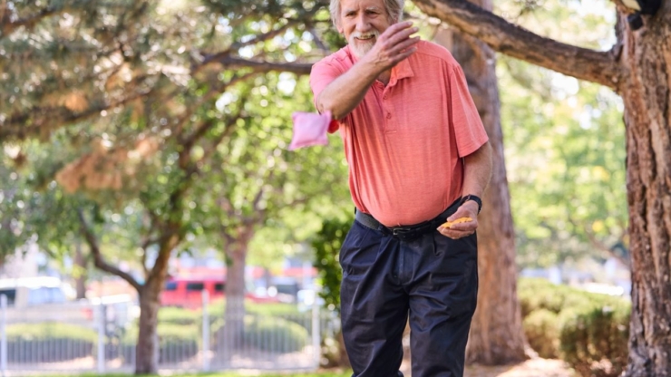 Engaged residents enjoy a lively outdoor game, fostering community and connection amid beautiful greenery.