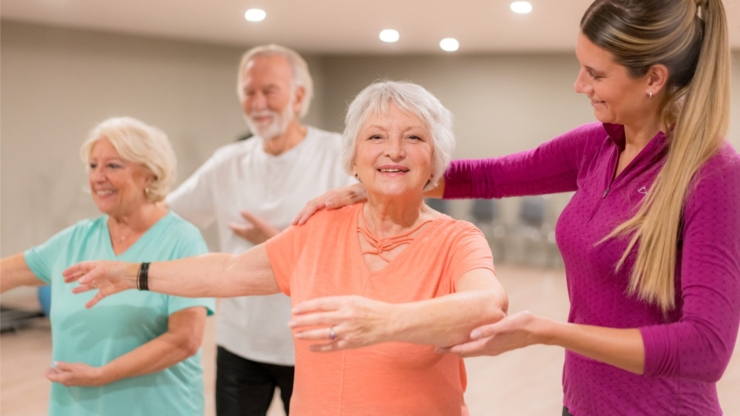 Engaging residents enjoy a movement session, fostering friendships and wellness in a bright, inviting space.