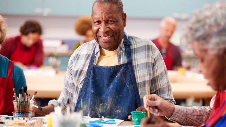 A vibrant art class brimming with laughter and creativity, showcasing engaged seniors sharing joyful moments.