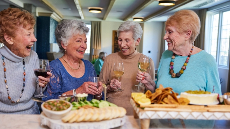 Lively gathering of friends sharing laughter, drinks, and delicious treats, highlighting community spirit.