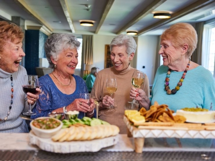 Lively gathering of friends sharing laughter, drinks, and delicious treats, highlighting community spirit.