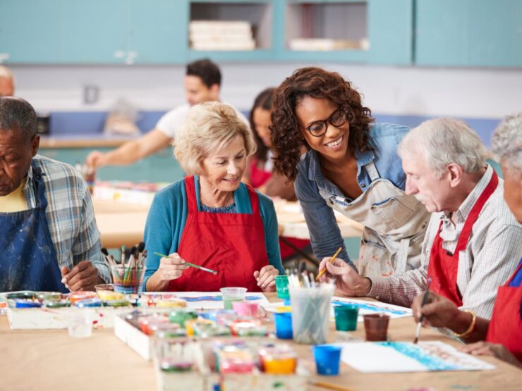 Seniors engage joyfully in art, fostering creativity and connection within a vibrant community.