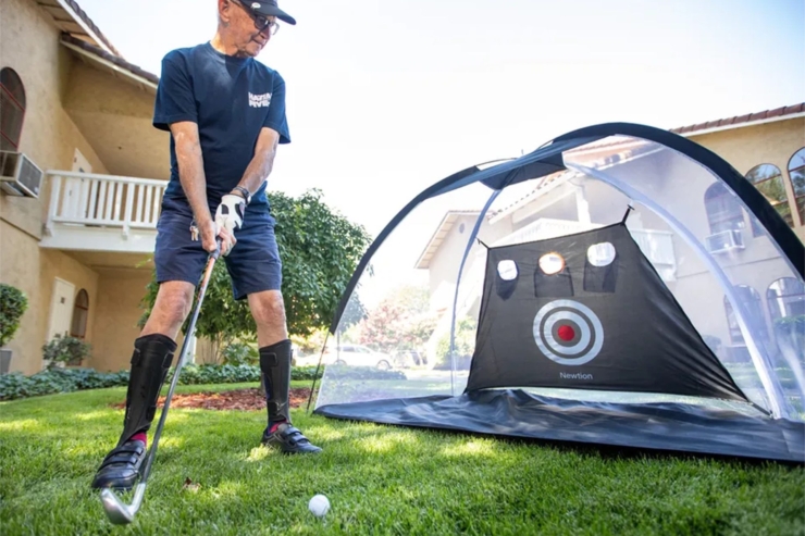 An engaged resident enjoys a sunny day practicing golf, fostering community and joy.