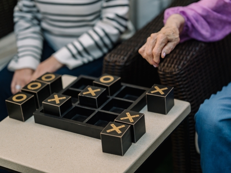 Engaging residents enjoy a friendly game of tic-tac-toe, fostering connection and joy.