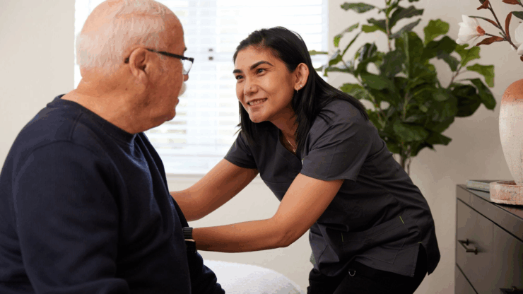 A warm interaction between a caregiver and resident, highlighting comfort and community in a cozy setting.