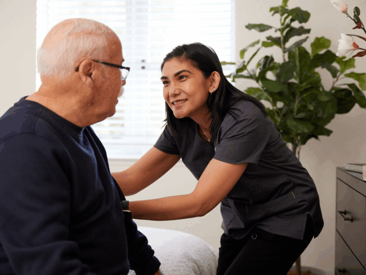 A warm interaction between a caregiver and resident, highlighting comfort and community in a cozy setting.