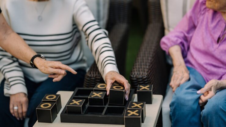 Engaging residents enjoy a lively game of tic-tac-toe, fostering connection and joy.
