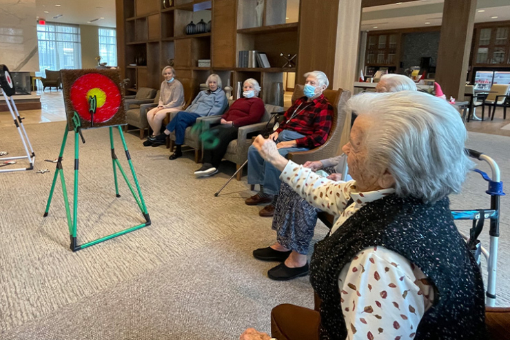 Seniors engage joyfully in a lively game, fostering connection and laughter in a welcoming space.
