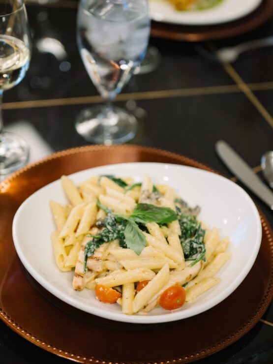 A beautifully plated pasta dish invites warmth and community, perfect for shared meals and connections.