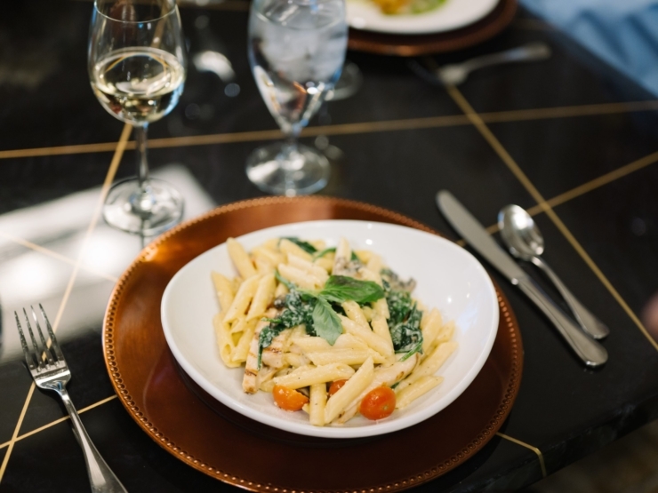 A beautifully plated pasta dish invites warmth and community, perfect for shared meals and connections.