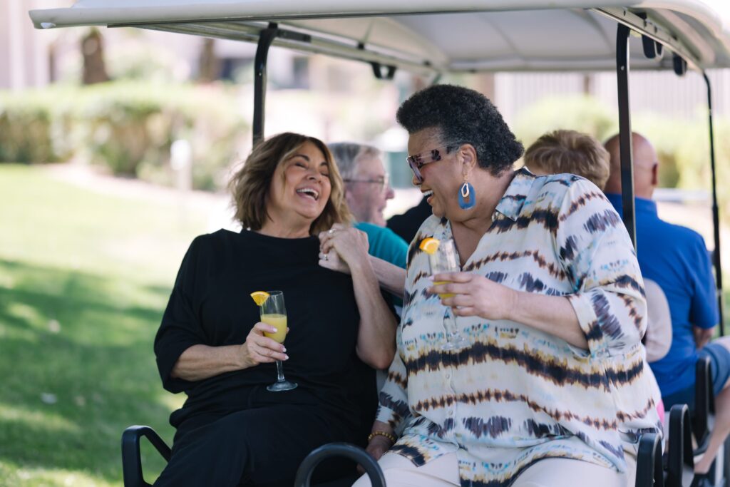 Laughter and joy fill the air as friends enjoy refreshing drinks together in a vibrant outdoor setting.