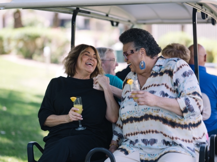 Laughter and joy fill the air as friends enjoy refreshing drinks together in a vibrant outdoor setting.