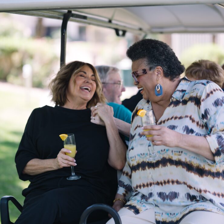 Laughter and joy fill the air as friends enjoy refreshing drinks together in a vibrant outdoor setting.