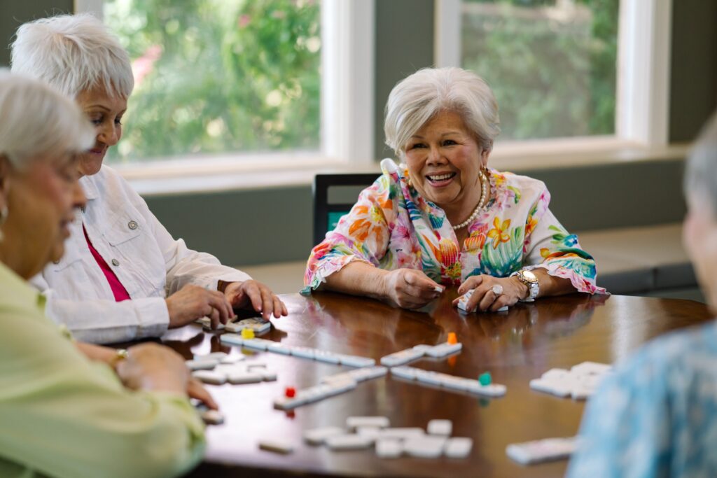 Lively residents enjoy a cheerful game, fostering friendship and connection in a warm setting.