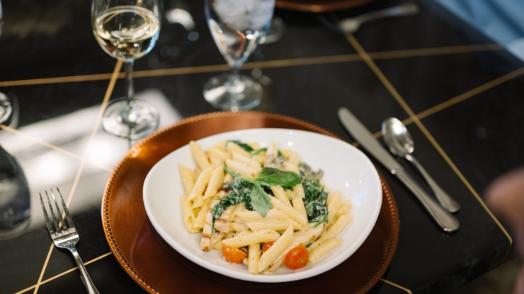 A beautifully plated pasta dish invites warmth and community, perfect for shared meals and connections.