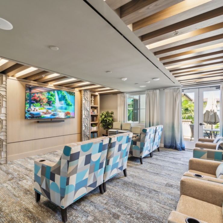 Bright, inviting lounge with vibrant seating, fostering community and relaxation for all residents.