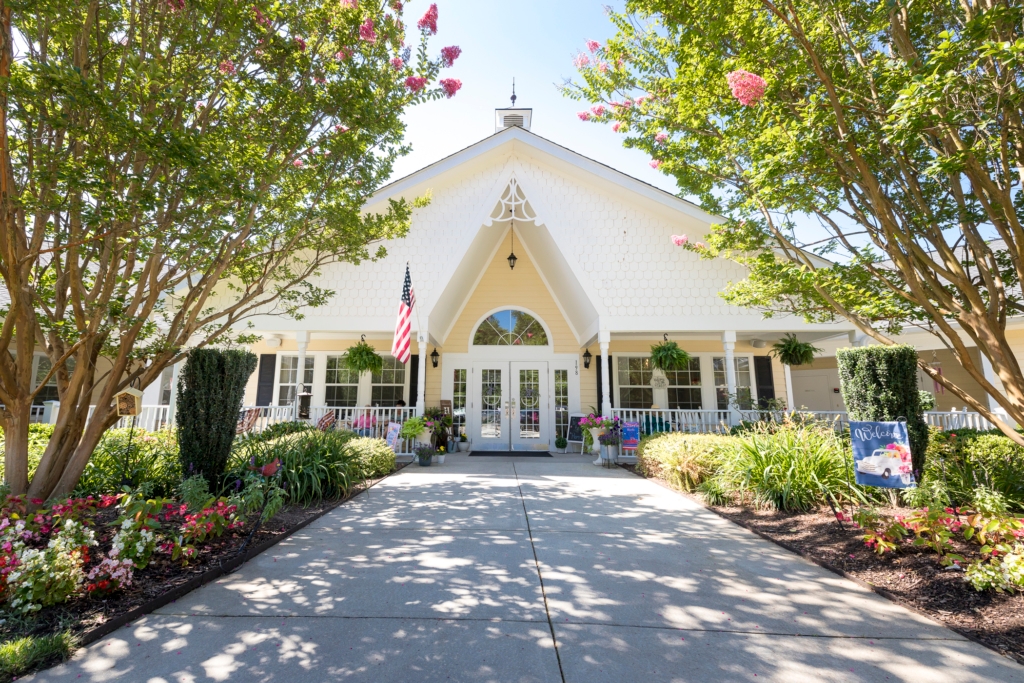 Welcoming entrance surrounded by vibrant flowers, inviting community spirit and comfort for all.