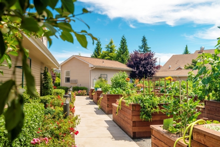 A vibrant garden pathway invites residents to enjoy nature and community in a serene, welcoming setting.