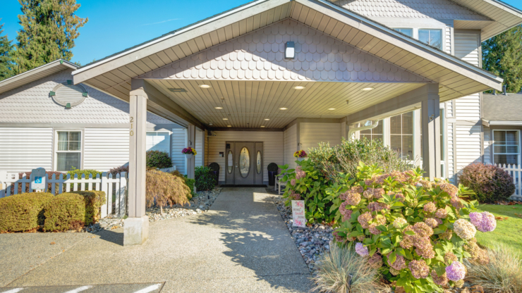 Welcoming entrance adorned with vibrant flowers, inviting a sense of community and comfort.