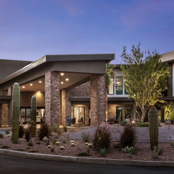 A welcoming entrance featuring lush landscapes and warm lighting, perfect for fostering community connections.