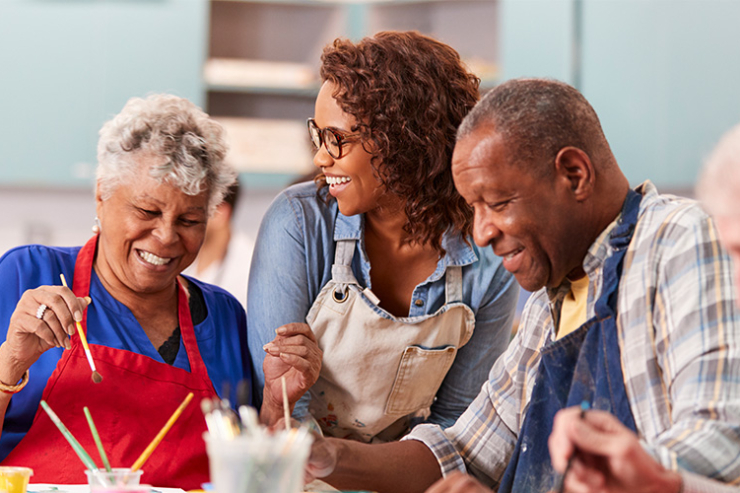 A joyful group shares creativity and laughter, fostering connections in a warm, inviting space.