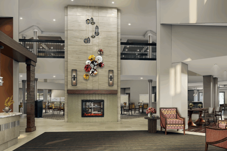 A welcoming lobby with cozy seating, a warm fireplace, and vibrant decor, fostering community and comfort.