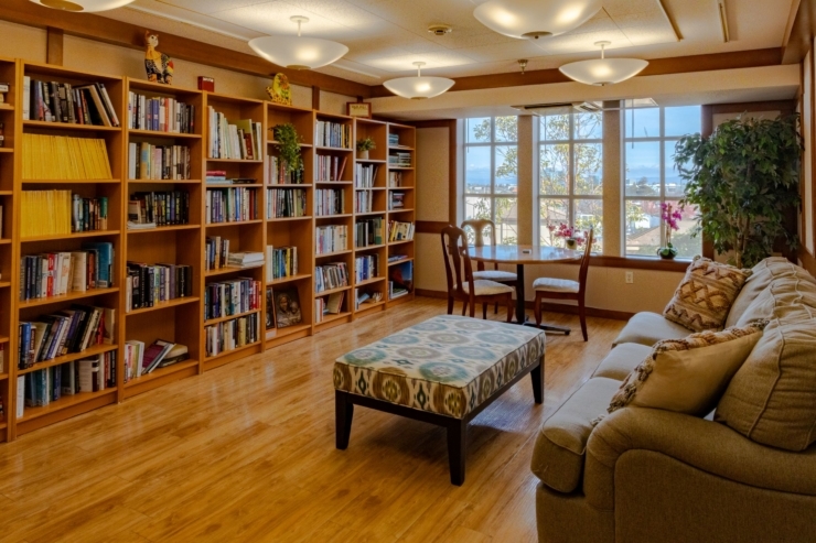 A welcoming space with bookshelves, comfortable seating, and natural light, perfect for community gatherings.