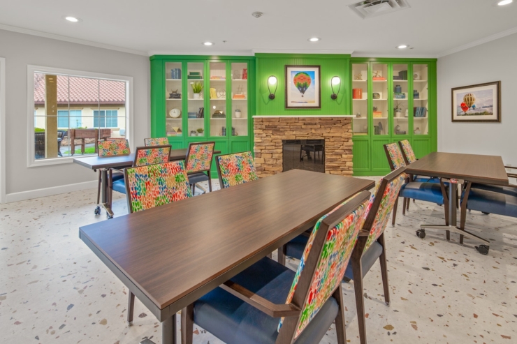 Bright and inviting, this communal space features colorful chairs and cozy decor, perfect for gatherings.