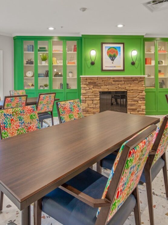 Bright and inviting, this communal space features colorful chairs and cozy decor, perfect for gatherings.
