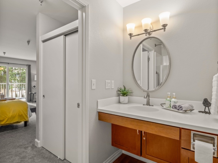 A bright, inviting bathroom leads to a cozy bedroom, radiating warmth and comfort.