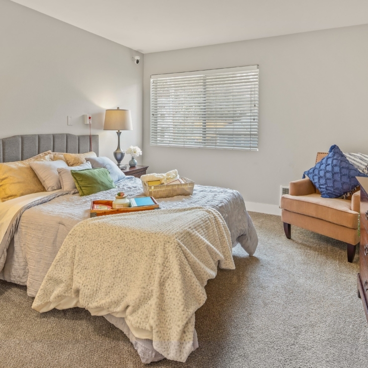 A welcoming bedroom featuring soft colors, comfortable furnishings, and a warm atmosphere for relaxation.