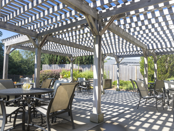 A welcoming outdoor space with shaded seating, perfect for gatherings and enjoying nature's beauty.